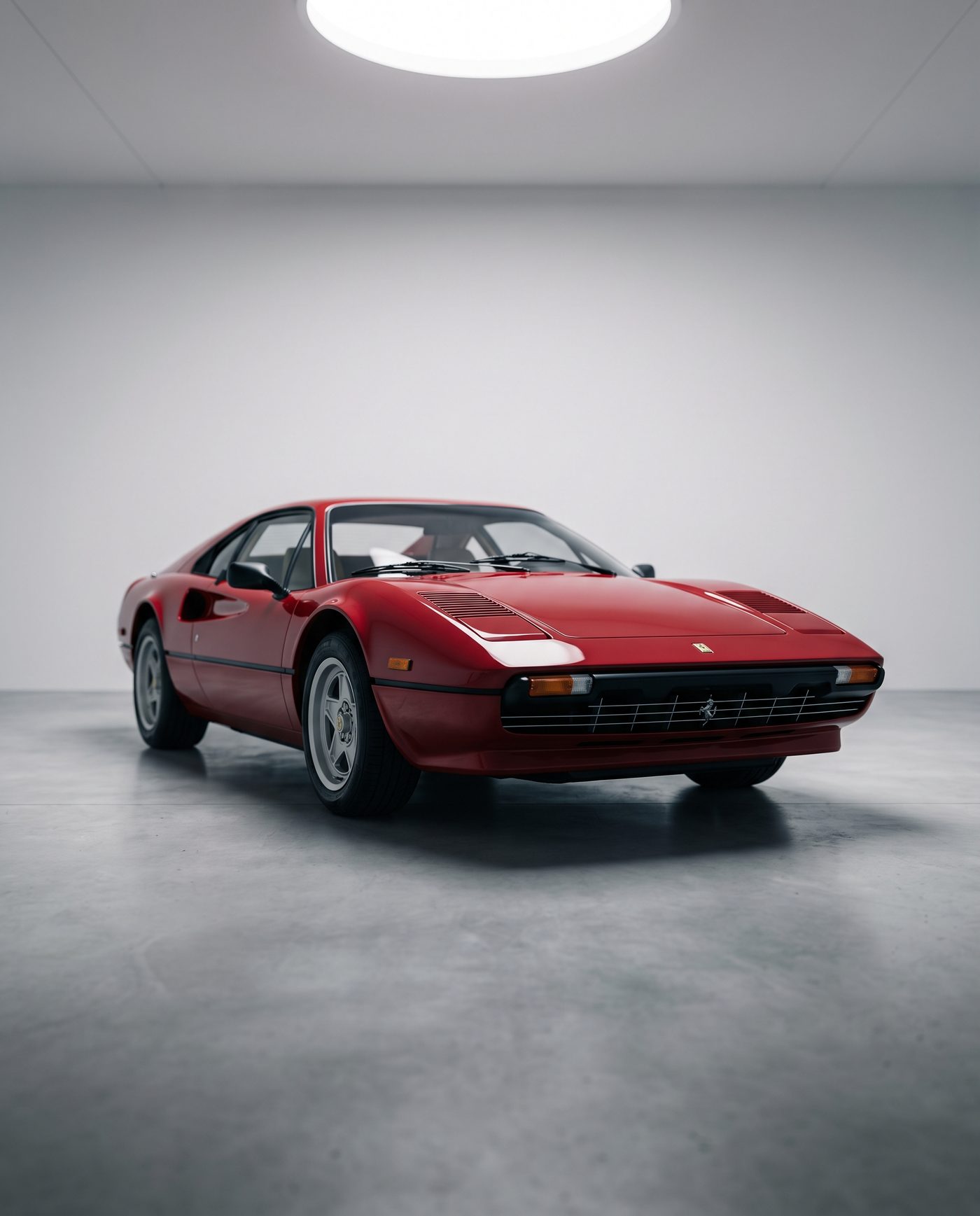 Restored 1989 classic sports coupe in deep red, three-quarter angle in a minimalist white studio garage